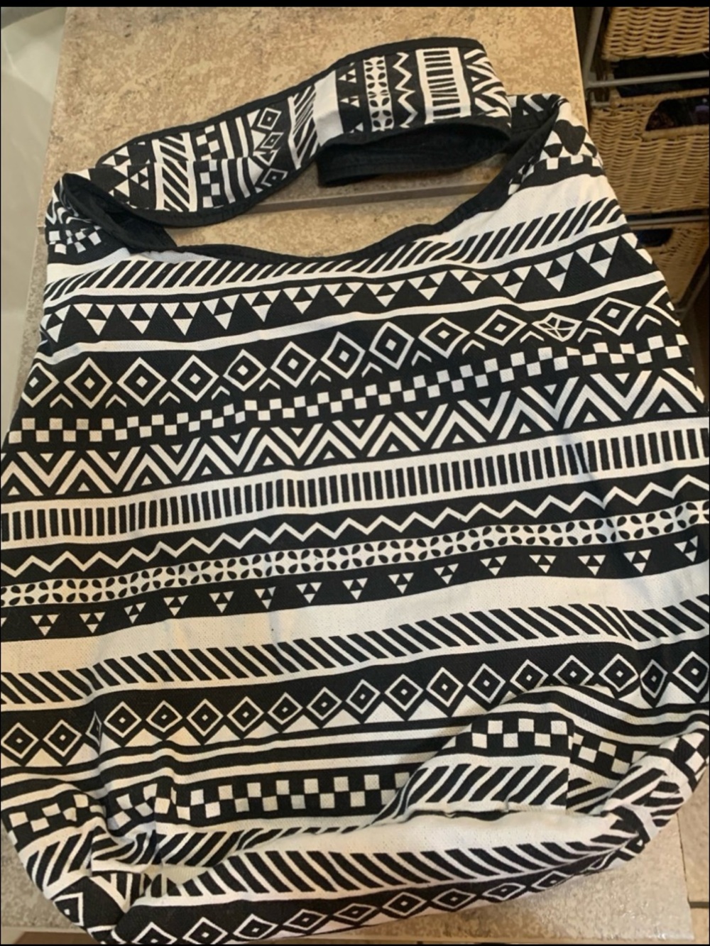 Black and White Aztec Hobo Bag Features a Bold Geometric Tribal Pattern.